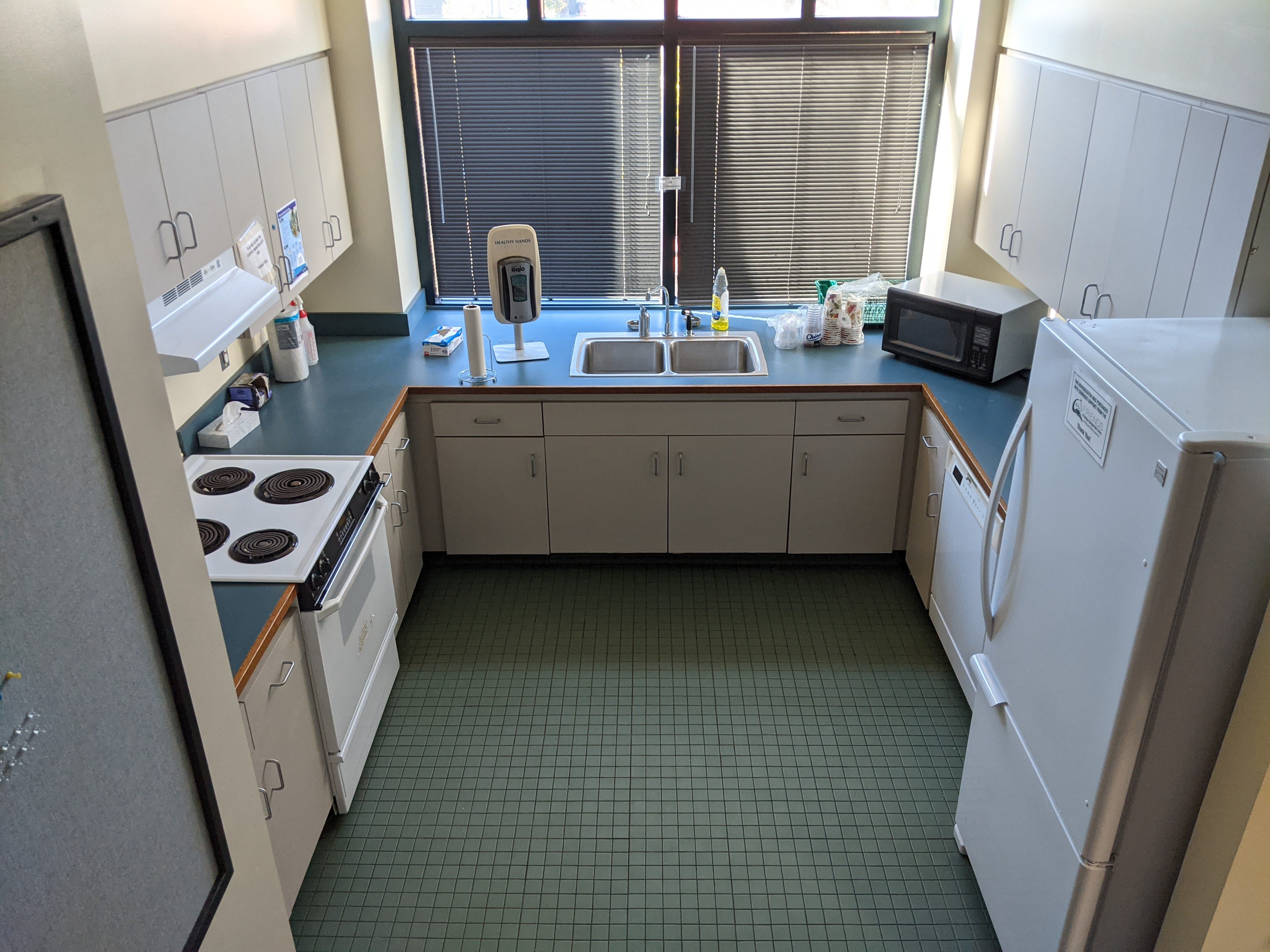 Full kitchen with refrigerator, dishwasher, microwave, sink, and an oven and electric range.