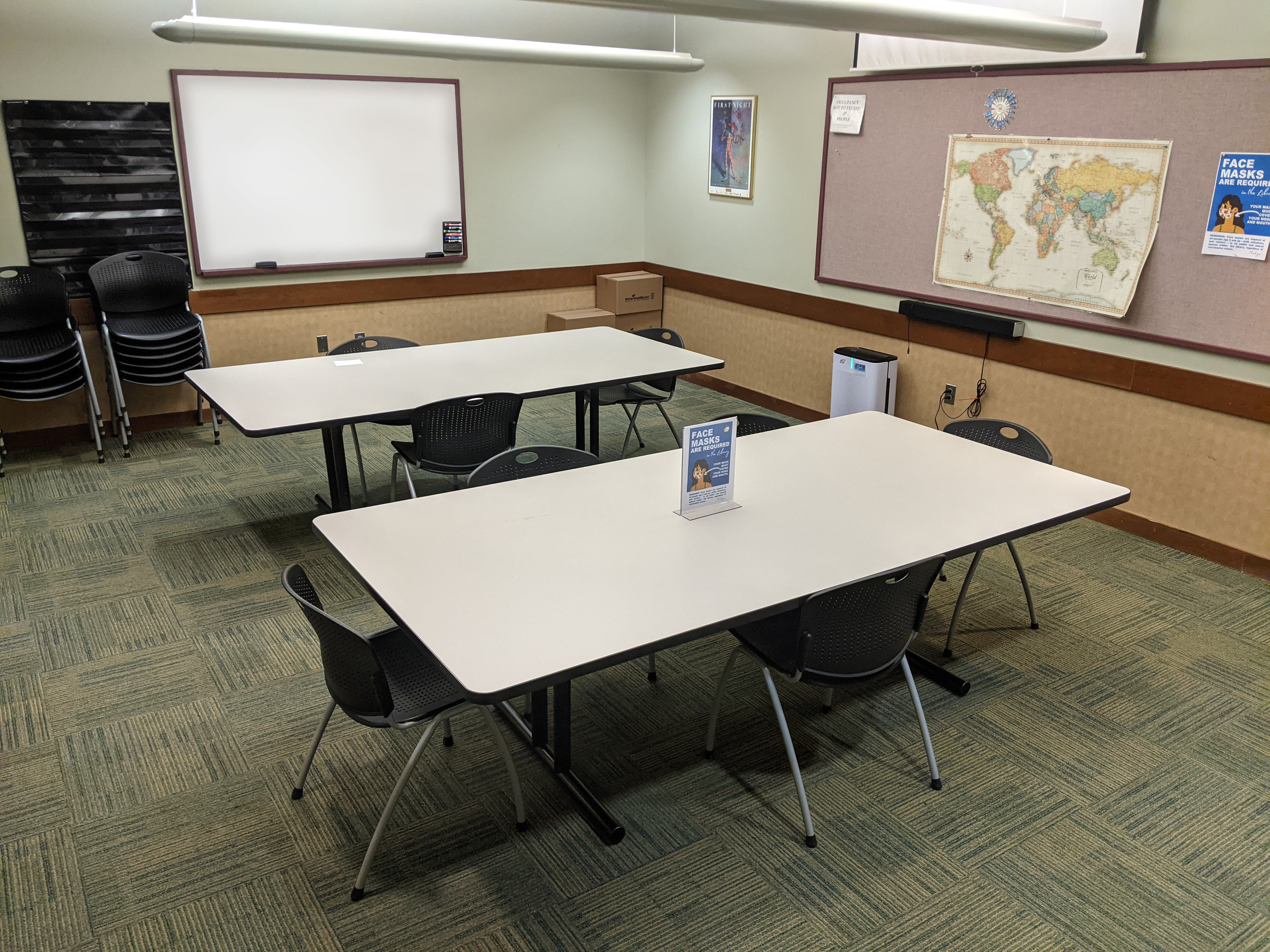 Tables and chairs viewed from the entrance side of the room.