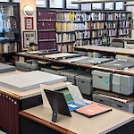 Thumbnail: Many books, papers, materials, and items shown on shelves, counters, in boxes, to showcase the large amount of materials available.