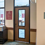 Thumbnail: Metal storage drawers with labels, a metal staircase ladder, and a wooden door with windows used as an entryway.